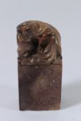 A GOOD CHINESE CARVED SOAPSTONE SEAL with a foo dog. 17cms high.