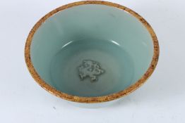 A CHINESE CELADON BOWL with caring character to the base. 19cms diameter.