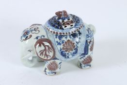 A CHINESE UNDERGLAZE RED, BLUE AND WHITE ELEPHANT INCENSE HOLDER. 17cms high.