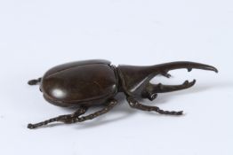 A JAPANESE BRONZE OKIMONO RHINO BEETLE with articulated wing. 10cms high.