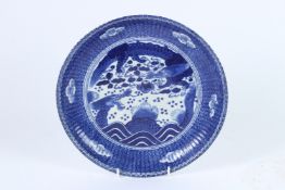 A JAPANESE IMARI BLUE AND WHITE PLATE. Dragons and clouds. 27cms wide.