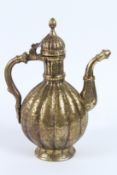 A FINE 18TH - 19TH CENTURY MUGHAL INDIAN ENGRAVED BRASS EWER. 30cms high.