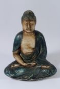 A POTTERY FIGURE OF THE BUDDHA sitting cross-legged. 32cms high.