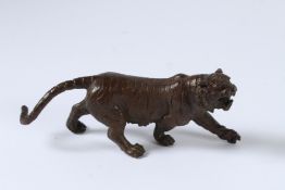 A JAPANESE BRONZE OKIMONO TIGER. 15cms long.