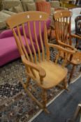 A Victorian style beech rocking chair.