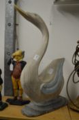 A large carved and painted model of a swan.