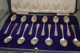 A cased set of twelve silver coffee spoons.