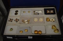 A collection of decorative earrings together with a quantity of jewellery display trays.