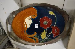 An Art Nouveau porcelain tray with metal mounts.