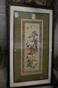 A pair of Japanese silk work pictures, framed and glazed together with another unframed picture.