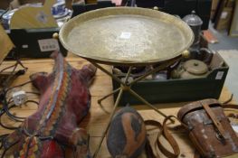An Eastern engraved brass tray with folding stand.