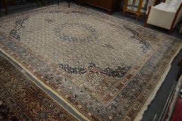 Large Persian carpet, cream ground with stylised decoration, some moth damage, 410cm x 300cm.