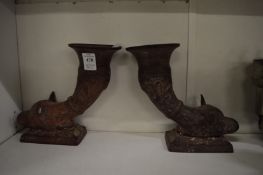 A pair of fox head cornucopia shaped patinated brass vases.