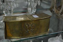 A brass box with hinged cover, the front applied with double headed eagle.