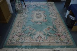 A Chinese carpet, green ground with floral decoration, 290cm x 186cm.