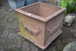 A large square shaped terracotta planter.