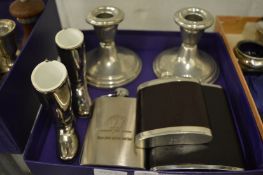 A pair of pewter candlesticks, three hip flasks and a pair of plated boots.
