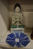 A small Japanese plate and an Oriental figure.