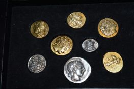 A cased set of reproduction ancient coins.