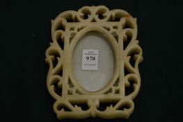 Carved alabaster photograph frame.