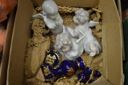 Three Lladro cherubs and other decorative china.
