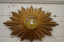 A sunburst wall clock.