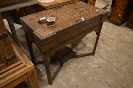 An Islamic inlaid folding games table (faults).
