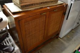 A hardwood two door cabinet.