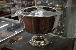 A polished metal four bottle wine cooler.