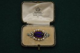 A gold, amethyst, pearl, diamond and enamel brooch with original fitted box.