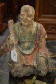 An 18th century carved a polychrome decorated seated Buddha.