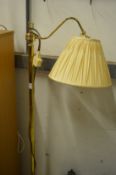 A brass floor standing lamp and a brass table lamp.