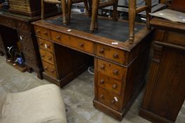 A Victorian small oak pedestal desk.