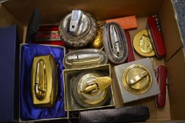 A collection of cigarette lighters and penknives.