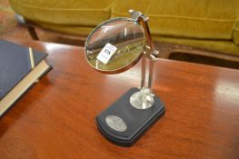 Magnifying glass on adjustable stand.