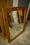 A large pine framed mirror.