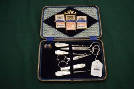 A leather cased sewing set.