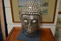 A silvered Buddhas head.