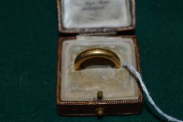 A 22ct gold wedding band.