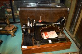 A cased Singer sewing machine.
