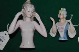 Two porcelain pin dollies.