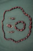 An amber style necklace, bracelet, earring and pendant set.
