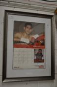 A signed Amir Khan photograph and page from a calendar, framed and glazed.