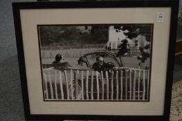 A photographic black and white print depicting Prince Phillip and Prince Charles in an open top