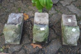 A set of three figural reconstituted stone plant pot feet.
