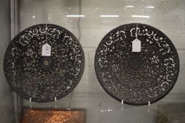 Two cast iron circular dishes.