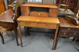 A 19th century mahogany desk with folding writing surface.