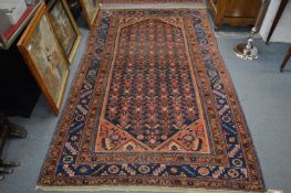 A Persian rug, blue ground with stylised decoration, 235cm x 140cm.