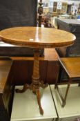 A Victorian figured walnut oval tripod occasional table.