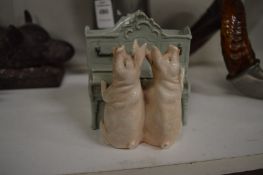 An amusing Continental porcelain vase modelled as two pigs playing a piano.